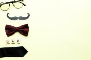 Flat lay happy father is day. Bow tie, glasses. inscription father photo