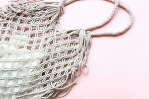Flat lay mesh bag on pink background. Zero waste. Ecology, rejection of plastic photo