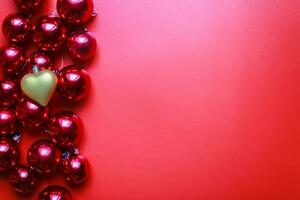 Christmas toys on a red background. Golden heart toy. Christmas decorations photo