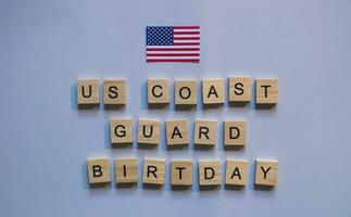 August 4, flag of the United States, US Coast Guard Day, minimalistic banner with the inscription in wooden letters photo