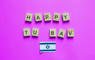 August 1-2, Jewish Day of Love, Tu be-Av, the Fifteenth of Ava, the flag of Israel, a minimalistic banner with an inscription in wooden letters photo