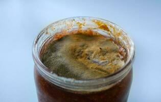 mold on raspberry jam, spoiled foods, mold jar, violation of cooking technology, health hazard, canned foods photo