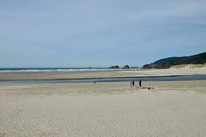 The long sandy beach at Canon Beach Oregon photo