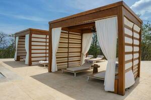 Luxury resort shelters with deckchairs photo