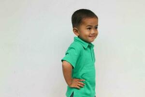 Portrait of a cute little Asian boy looking at white space and smiling, on the white background photo