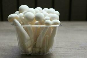 White beech mushrooms, Shimeji mushroom, Edible mushroom on the wooden table photo