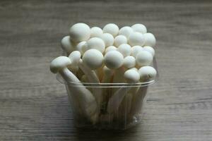 White beech mushrooms, Shimeji mushroom, Edible mushroom on the wooden table photo