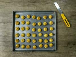 Nastar Keju. Homemade Pineapple Tart or Nastar Keju, cookies with pineapple jam filled and spread grated cheese on the aluminium pan, fresh from the oven. Served during Eid Al Fitri photo