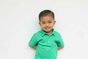 Portrait of a cute little Asian boy looking at camera and smiling, on the white background photo