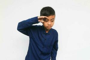 Curious boy looking and find something isolated on the white background photo