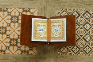 Muslim holy book Al-Quran in the mosque, Quran on a wooden board with ornament tile photo