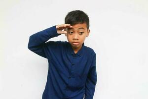 Curious boy looking and find something isolated on the white background photo