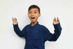 Surprised boy wearing a blue casual shirt Isolated on white background photo