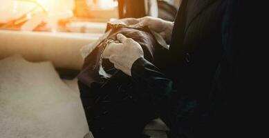 tailor is holding a cloth photo