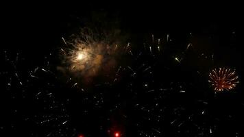 Beautiful festive fireworks in the night sky in the city. Holiday Christmas and New Year, celebration concept video