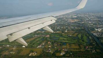 View of the wing of the aircraft through the porthole. Climb, passenger flight takeoff video