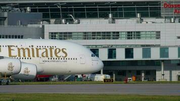 DUSSELDORF, GERMANY JULY 21, 2017 - Airbus A380 Emirates A6 EUC taxiing after landing at sunset. Dusseldorf airport video