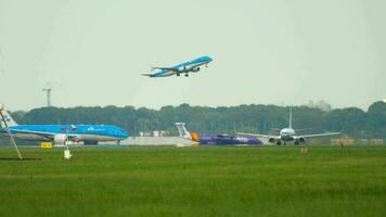 AMSTERDAM, THE NETHERLANDS - JULY 25, 2017 KLM Royal Dutch Airlines Boeing 737 PH-BXA in retro livery accelerate at runway 24 Kaagbaan and KLM Embraer take-off at Aalsmeerbaan video