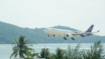 PHUKET, THAILAND DECEMBER 2, 2016 - Thai Airways Airbus 330 HS TED approaching before landing on the Phuket airport. View from the top floor of the hotel Centara Grand West Sands Resort Phuket video