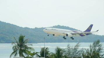 PHUKET, THAILAND DECEMBER 2, 2016 - Thai Airways Airbus 330 HS TED approaching before landing on the Phuket airport. View from the top floor of the hotel Centara Grand West Sands Resort Phuket video