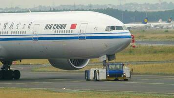 FRANKFURT AM MAIN, GERMANY JULY 17, 2017 - Air China Boeing 777 B 7952 towing by tractor from service. Fraport, Frankfurt, Germany video