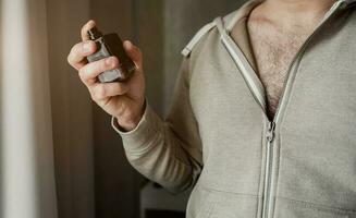 Man with a bottle of perfume photo