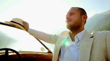 Happiness lifestyle portrait of young man in vintage style enjoying boat ride relaxing on lake video