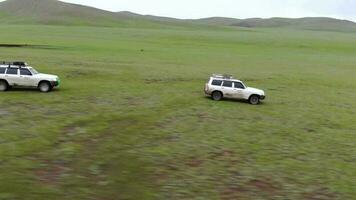 Two 4X4 Suv Cars Driving in The Treeless Vast Meadow video