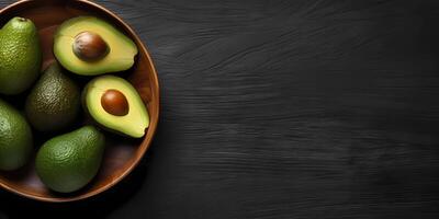 Avocado fruit on bowl copy space dark background, AI generated photo