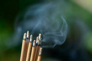 Burning incense with smoke photo