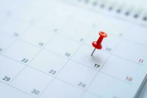 Planning for a business meeting, red pin on the 17th day on the calendar photo