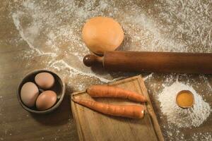 Egg dough for noodles, with ingredients on the table, traditional italian cuisine. photo
