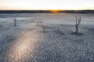 Cracked earth, desertification process,abstract background photo