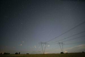 High voltage power line in a nocturnal landscape, La Pampa, Patagonia, Argentina. photo