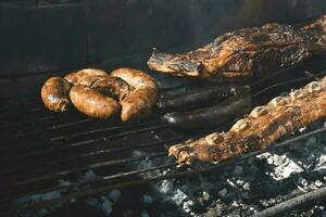 Barbecue, grilled sausages and cow meat , traditional argentine cuisine photo