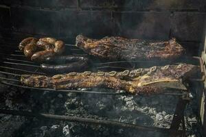 Barbecue, grilled sausages and cow meat , traditional argentine cuisine photo