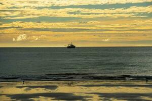 Ship in marine landscape at evening, Patagonia, Argentina. photo