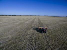 Tractor and seeder, direct sowing in the pampa, Argentina photo