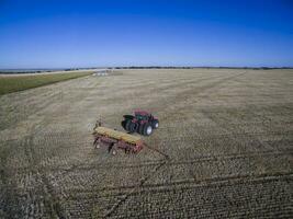 Tractor and seeder, direct sowing in the pampa, Argentina photo