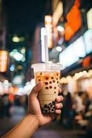 Generative AI illustration of hand holding Taiwan milk tea and blurry background photo