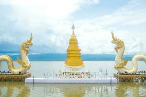 The Golden pagoda and Twin Naga an iconic landmark in Phayao lake, Thailand. photo