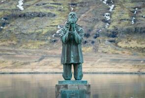 Eskifjordur, Iceland - March 22 2015 - An iconic statue in Eskifjordur, the statue dedicated to victims of sea in Eastern Iceland. photo