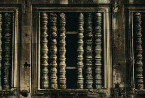 The mystery rock window in ancient Khmer traditional of Angkor Wat, Siem Reap of Cambodia. photo