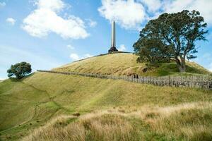 The memorial obelisk on the top of One Tree Hills volcano in Auckland, New Zealand. photo