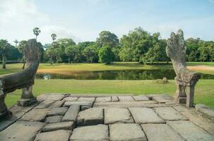 The Nagas statue on the steps down from the causeway of Angkor Wat in Siem Reap of Cambodia. photo