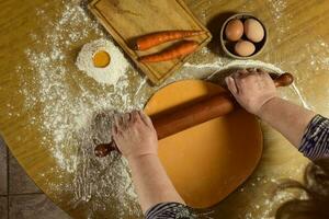 Egg dough for noodles, with ingredients on the table, traditional italian cuisine. photo