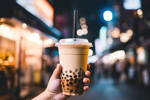 illustration of hand holding Taiwan milk tea and blurry background photo