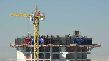 Cranes and construction workers working at a major video