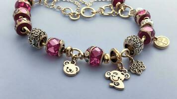 Charming Joy Celebrating National Teddy Bear Day with a Teddy Bear Charm Bracelet. AI Generated. photo