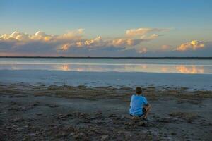 Boy contemplate the horizon, La Pampa Province, Argentina photo